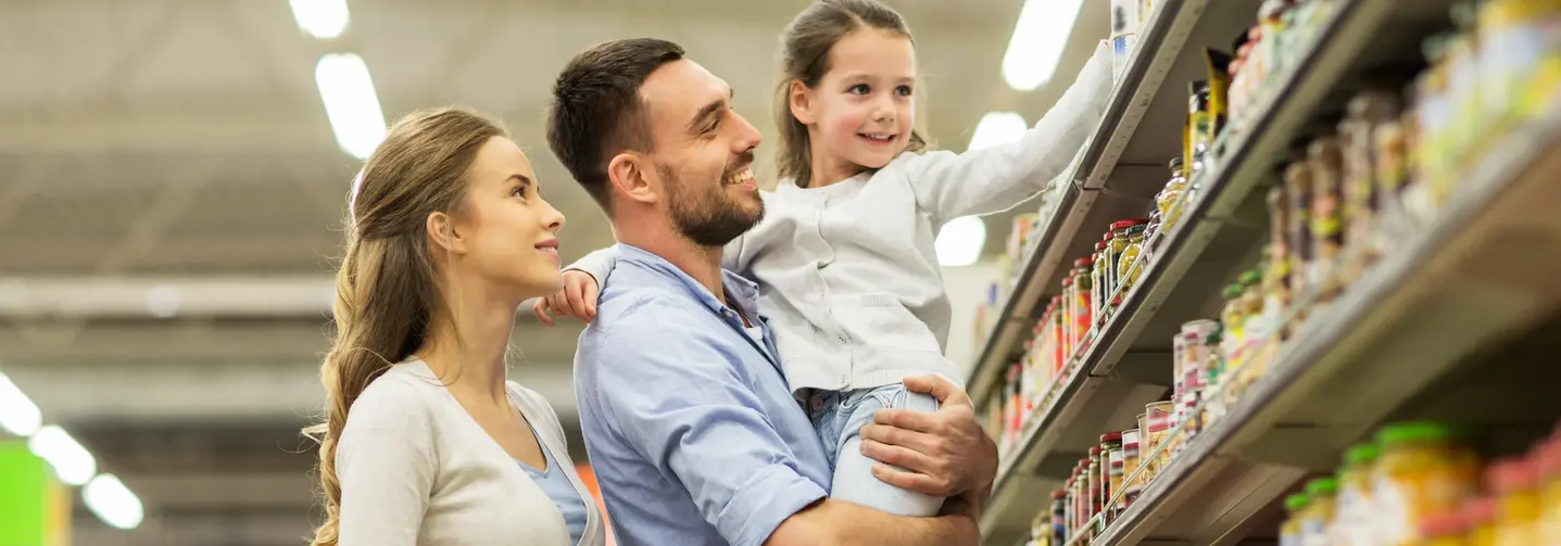 Fröhliche Familie beim Lebensmitteleinkauf im Supermarkt.